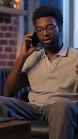 African American business man call mobile phone entrepreneur businessman overtime in night office smiling guy employer talk smartphone friendly male consulting client cellphone chatting cell talking video