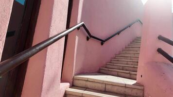 Steps leading up a pink-walled staircase in a cozy location video