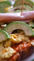 Healthy toast with avocado and vegetables for breakfast video