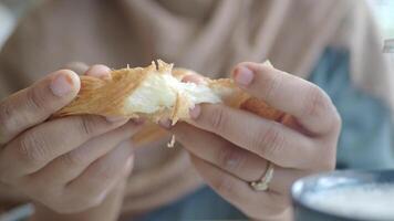 Enjoying a flaky pastry at a cozy cafe video