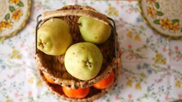 Freshly picked pears and oranges in rustic baskets on table video