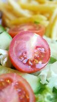 Fresh salad with tomatoes and greens in close view video