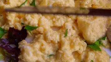 Scrambled eggs with herbs and greens prepared at home video