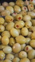 Fresh green olives soaking in brine solution at local market video