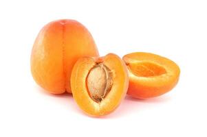 Fresh Ripe Apricots Whole and Sliced on a White Background photo
