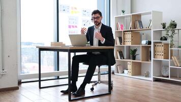 Professional adult male in office setting presenting report showing growth chart and positive trends. Business documentation and model analysis concepts. video