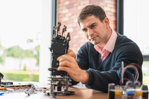 Robotics Engineer Working on Advanced Prosthetic Arm, Man Assembles Bionic Hand Prototype, Scientist Developing Robotic Limb, Innovation in Progress photo