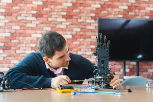Man Assembles Bionic Hand Prototype, Robotics Engineer Working on Advanced Prosthetic Arm, Scientist Developing Robotic Limb, Innovation in Progress photo