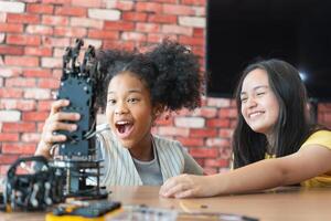 Girls Engaged in Robotics and STEM Learning, Diverse Kids Building a Robot Arm in a Science Workshop, Two Girls Exploring Technology and Innovation, Future Engineers photo