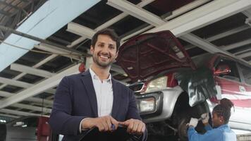 Latin male mechanic manager arms crossed and cheerful at fix car garage. video