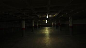 Concrete pillars support the low ceiling of an underground parking garage, illuminated by rows of fluorescent lights, creating a stark and eerie atmosphere, slow camera rotation video