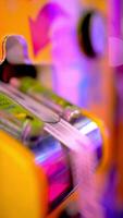 Ticket dispenser machine in vibrant arcade environment, human hand extracting colorful winning ticket from electronic gaming mechanism during entertainment moment video