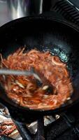 Skilled chef carefully stirring golden brown onions in sizzling wok, expertly managing heat while releasing rich, caramelizing flavors through precise culinary technique video