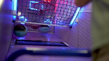 Energetic arcade basketball game player competing intensely, shooting for maximum points before timer expires, showcasing determination and skill through dynamic montage video
