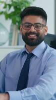 Vertical view happy smiling Arabian ethnic Muslim business man Indian businessman typing computer focused with online work looking at camera positive male professional guy corporate manager at table video