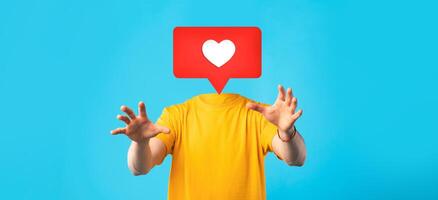 A person in a yellow shirt reaches out with their hands, while a large heart icon floats above where their head should be. photo