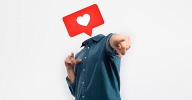 A person stands against a plain background, pointing confidently while a heart icon hovers above where their head would be. This playful representation captures the essence of social media engagement. photo