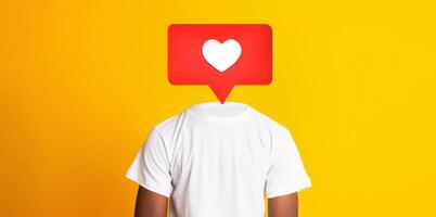 A person stands with their back turned, wearing a white t-shirt against a bright yellow background. A red heart icon appears instead of their head, symbolizing social media interactions. photo