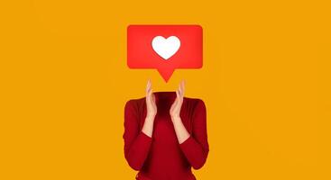 A person claps in approval with a heart symbol instead of their head. Bright yellow background enhances the cheerful atmosphere, highlighting themes of connection and appreciation on social platforms. photo