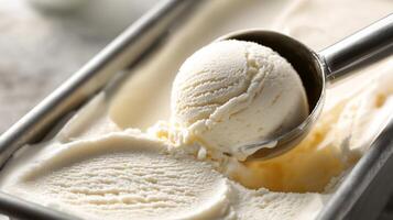A close-up of creamy vanilla ice cream being scooped from a container, showcasing its rich texture. photo
