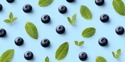 Blueberries and Mint Leaves Pattern on Light Blue Background Food Photography Seamless Texture photo