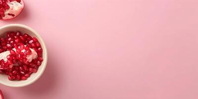 pomegranate with ice cream on pink background photo