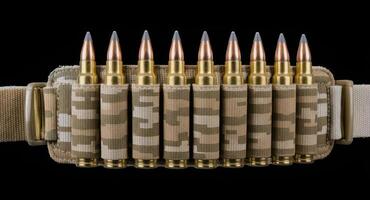 Desert camouflage ammunition belt with ten brass bullets on black background photo