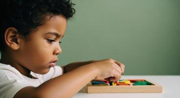 Young african american boy deeply focused playing with a colorful wooden puzzle photo