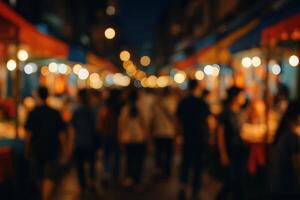 Blurred night market scene with crowded street and warm bokeh lights photo