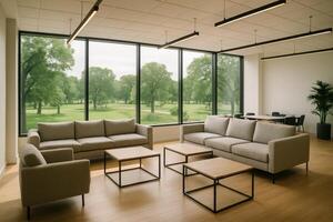 Modern co working space common area with sofas and tables overlooking green park photo