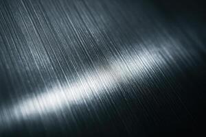 Close up of brushed metal surface with fine lines and light reflection photo