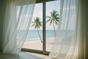 Tropical beach view from a room with sheer white curtains blowing in the breeze photo