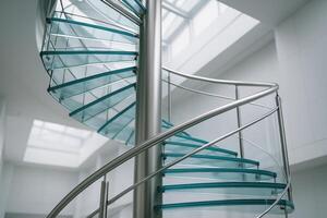 Modern minimalist spiral staircase with transparent glass treads and sleek stainless steel railing photo