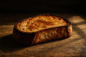 Close up of a single slice of toasted sourdough bread on a rustic wooden table photo