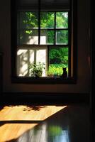 Black cat sitting on window sill enjoying sunlight and garden view photo