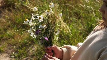 A child holding a bouquet of wildflowers video