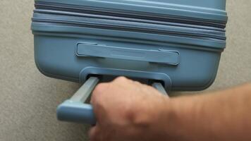 A person is pulling a suitcase with a handle video