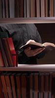 A person reading a book in a library video