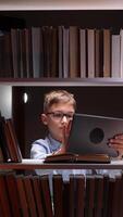 A young boy in glasses is using a tablet computer video