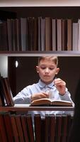 A boy is reading a book in a library video