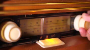 A person is holding a radio in front of an old fashioned radio video