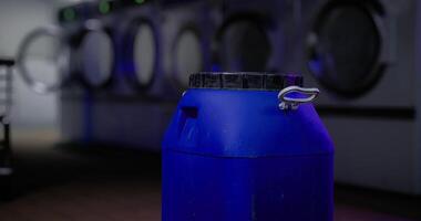A CGI Blue container in a laundromat with washing machines in the background video