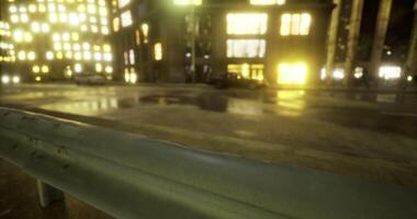 Photorealistic CGI City street at night with illuminated buildings and wet pavement video