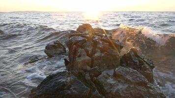 Huge wave hits rock, slow motion camera splash video