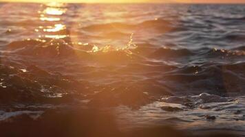 Sunset wave splash and droplets, slow motion video