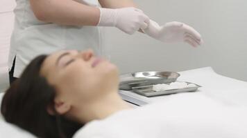 A cosmetologist prepares for a lip augmentation procedure. Beauty injections on the lips. video