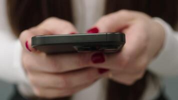 Close-up of a smartphone in the hands of a young woman who is browsing the Internet. Communicating on social networks, shopping and working online, blogging and modern technologies. video