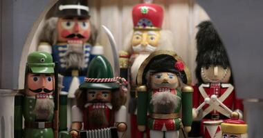 Cheerful array of nutcracker soldiers displayed for the holiday season. Christmas decorations. Focus moves from foreground to background. video