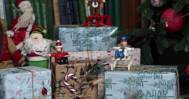 Explore creative Christmas home decor with an array of wrapped gifts. Enjoy the festive ambiance enhanced by colorful ornaments and charming holiday figures. Get inspired for your own celebrations. video