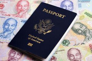 American passport on Vietnamese Dong photo